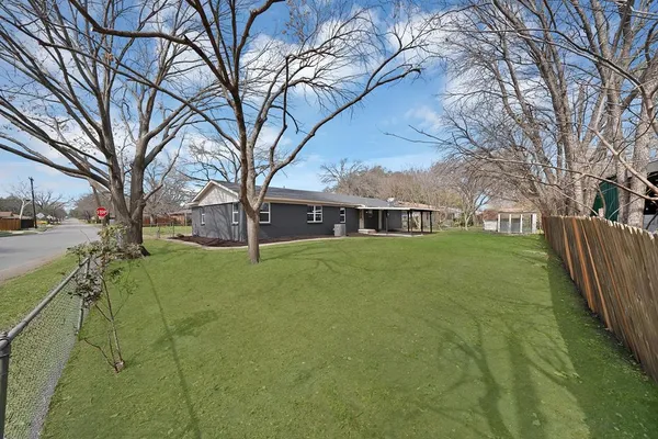 a view of house with yard