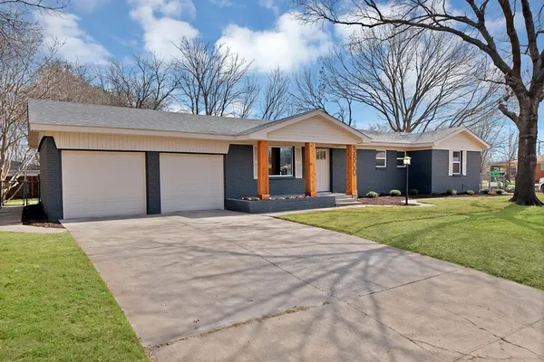 a front view of house with yard and green space