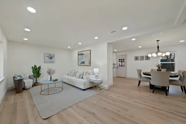 a living room with furniture and a chandelier