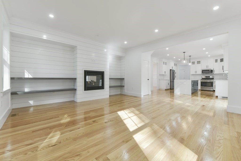30 Oscars Way Dedham, MA 02026 - Photo 12 of 39 a view of a living room a refrigerator and a fireplace