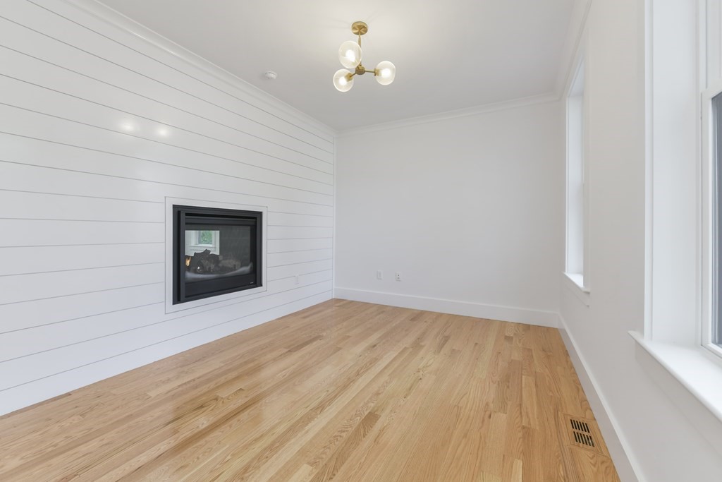 30 Oscars Way Dedham, MA 02026 - Photo 15 of 39 a view of empty room with wooden floor and fan