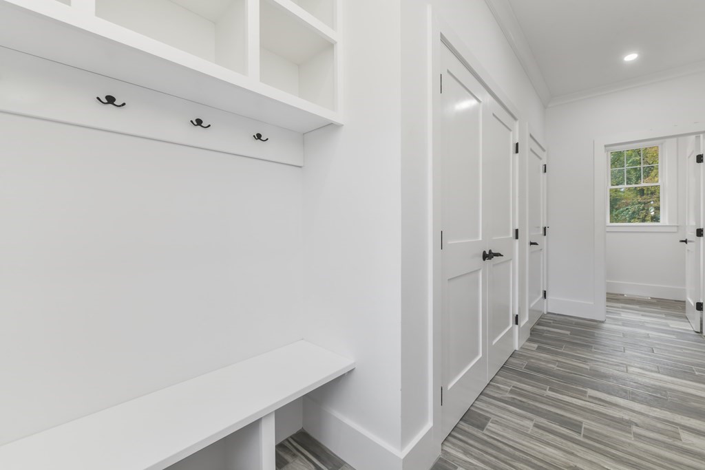 30 Oscars Way Dedham, MA 02026 - Photo 19 of 39 a view of a hallway with wooden floor