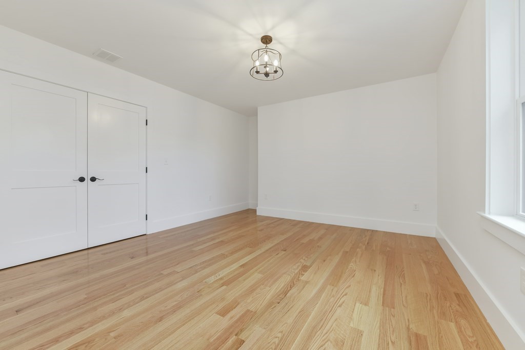 30 Oscars Way Dedham, MA 02026 - Photo 22 of 39 a view of a room with wooden floor and a ceiling fan