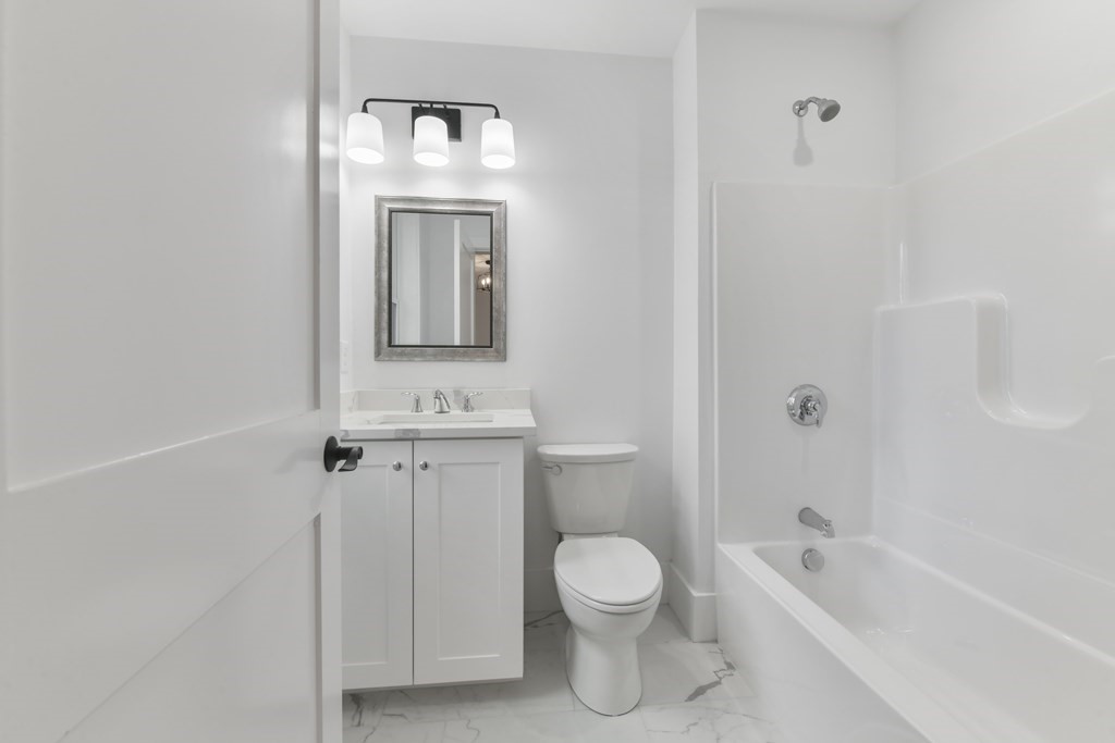 30 Oscars Way Dedham, MA 02026 - Photo 25 of 39 a bathroom with a toilet a sink and bathtub