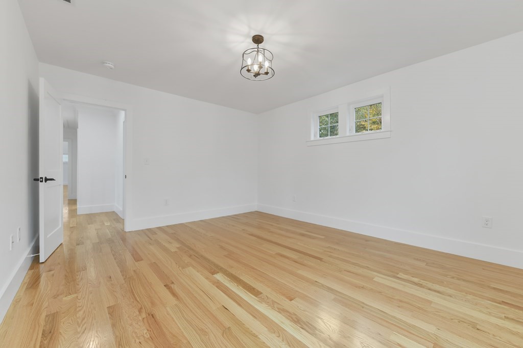 30 Oscars Way Dedham, MA 02026 - Photo 26 of 39 a view of empty room with wooden floor
