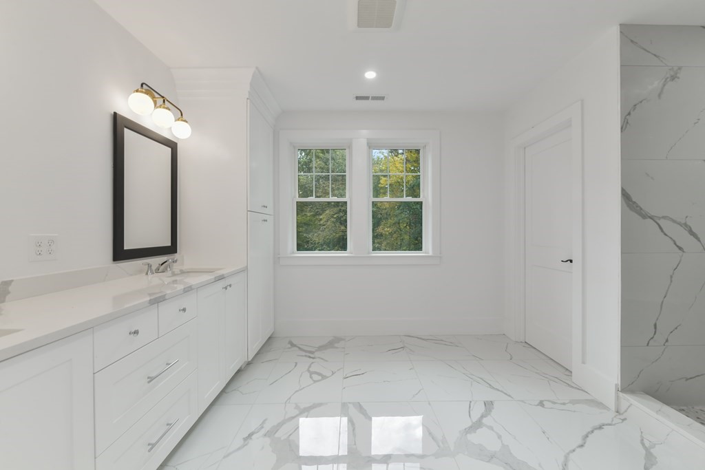 30 Oscars Way Dedham, MA 02026 - Photo 33 of 39 a bathroom with a sink and a mirror