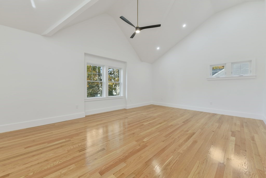 30 Oscars Way Dedham, MA 02026 - Photo 37 of 39 a view of an empty room with a window and wooden floor