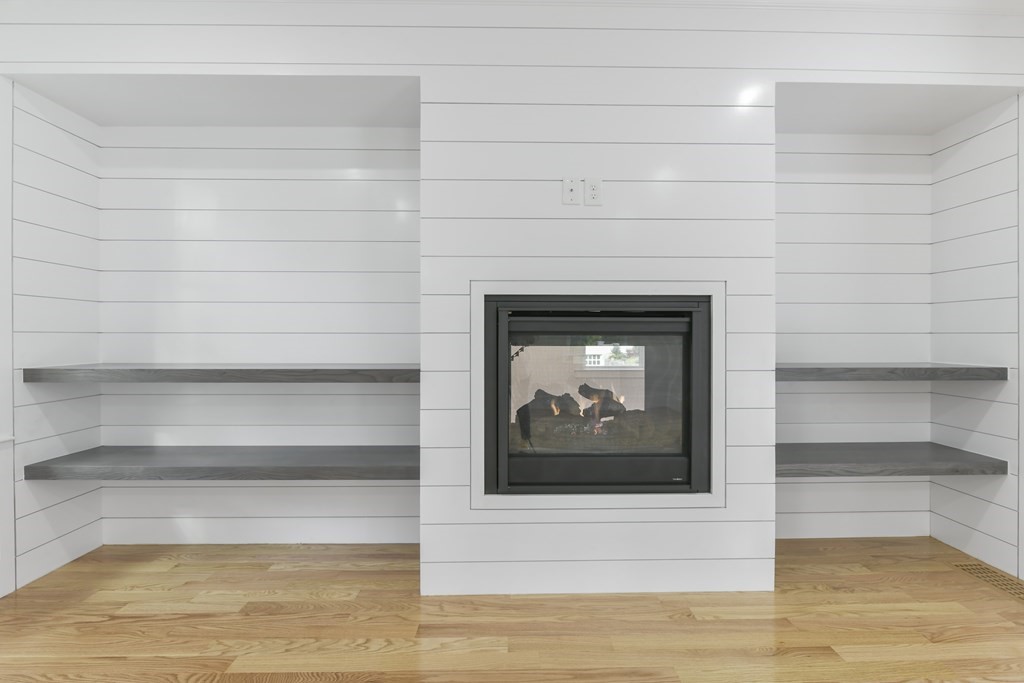 30 Oscars Way Dedham, MA 02026 - Photo 10 of 39 a living room with a fireplace and a rug