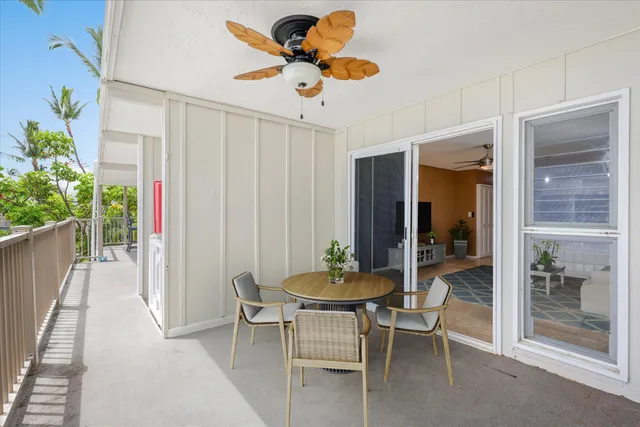 a dining room with furniture and a potted plant