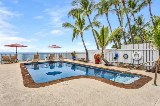 a view of a swimming pool with a lounge chair