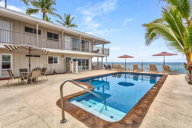 a view of swimming pool with outdoor seating and city view