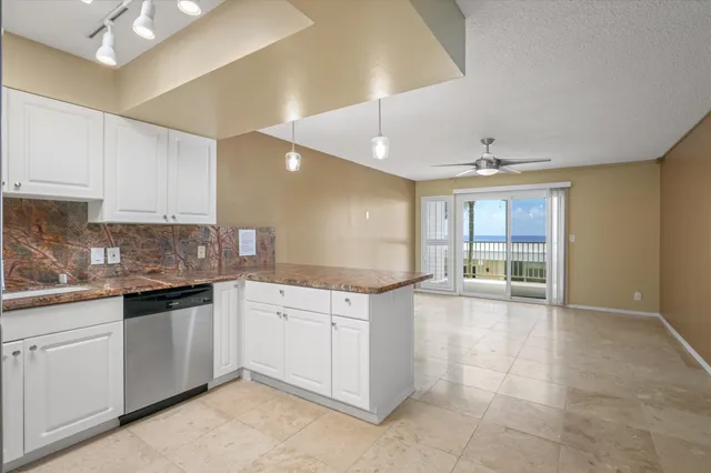 a kitchen with granite countertop a stove sink and cabinets