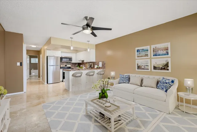 a living room with furniture and kitchen view