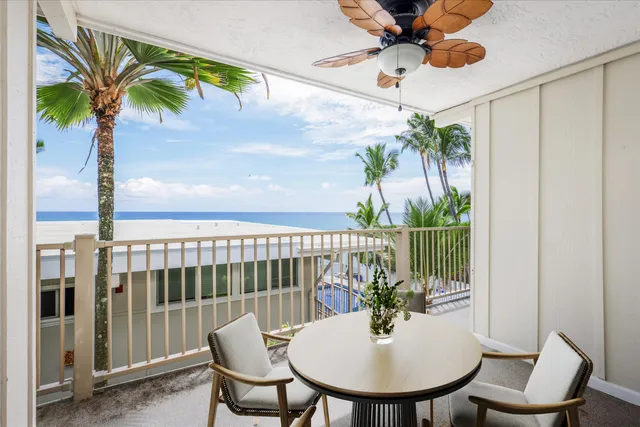 a view of a balcony with a table and chairs