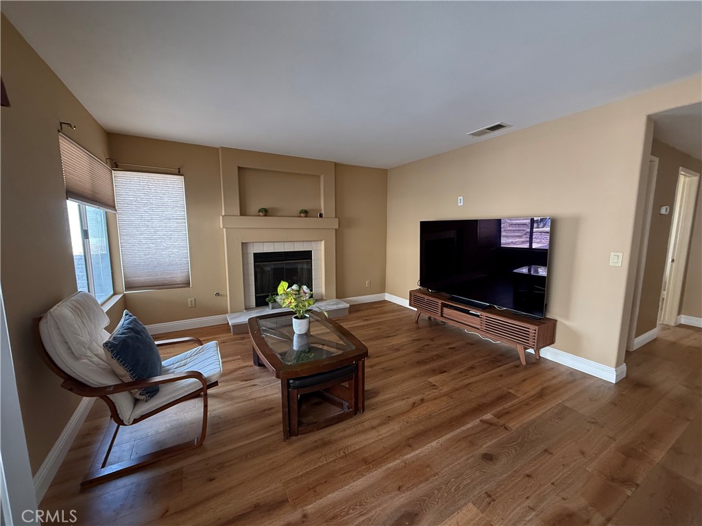 21182 Tennyson Road Moreno Valley, CA 92557 - Photo 15 of 36 a living room with furniture a flat screen tv and a fireplace
