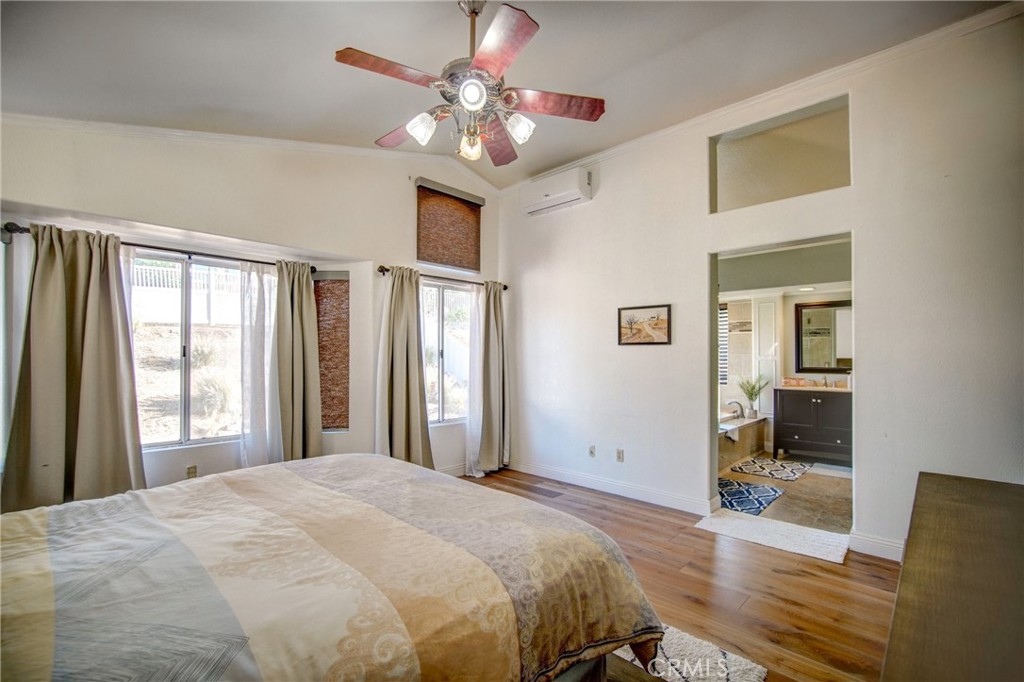 21182 Tennyson Road Moreno Valley, CA 92557 - Photo 20 of 36 a bedroom with a bed and a chandelier