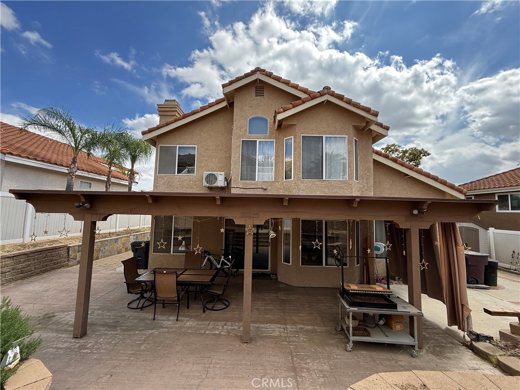 21182 Tennyson Road Moreno Valley, CA 92557 - Photo 31 of 36 a view of a house with a patio and a yard