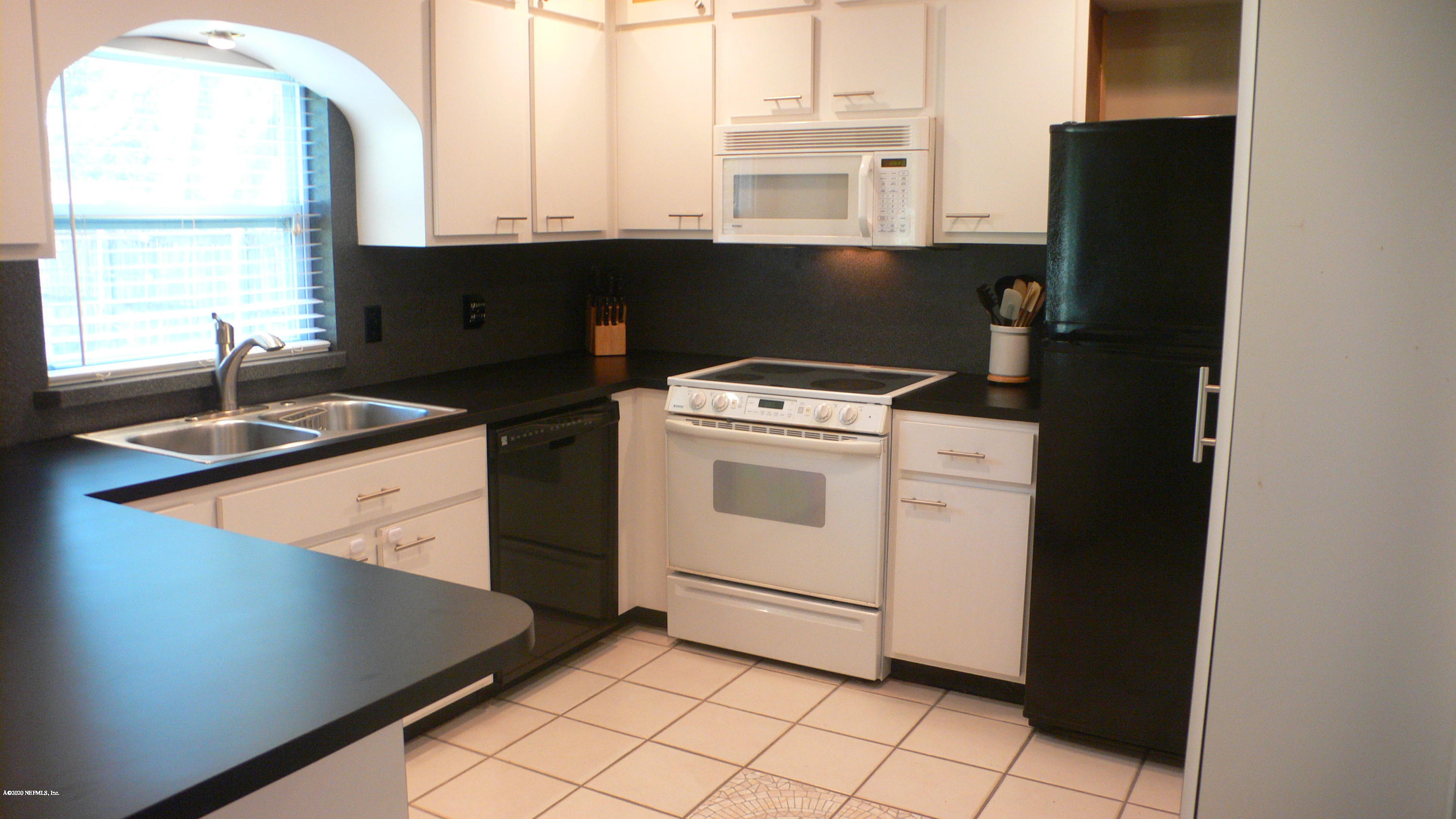 12779 Attrill Road Jacksonville, FL 32258 - Photo 3 of 11 a kitchen with a stove and a refrigerator