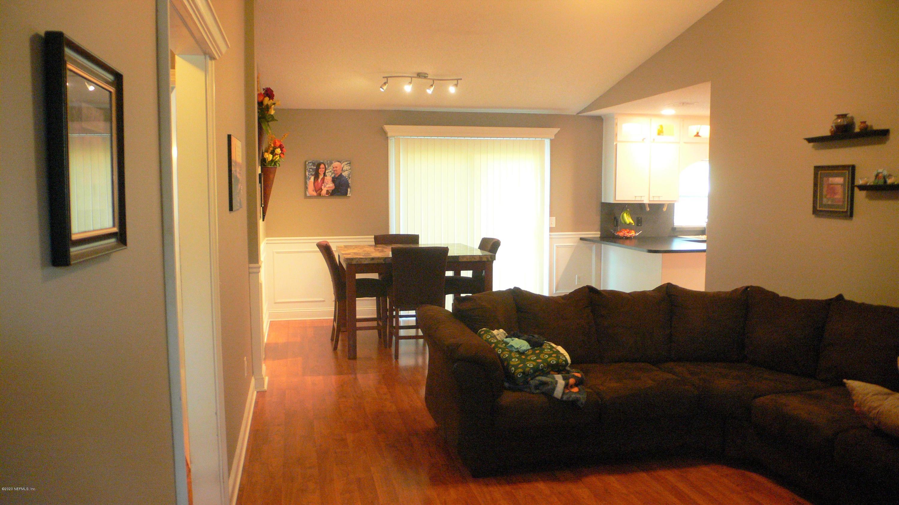12779 Attrill Road Jacksonville, FL 32258 - Photo 5 of 11 a living room with furniture and wooden floor