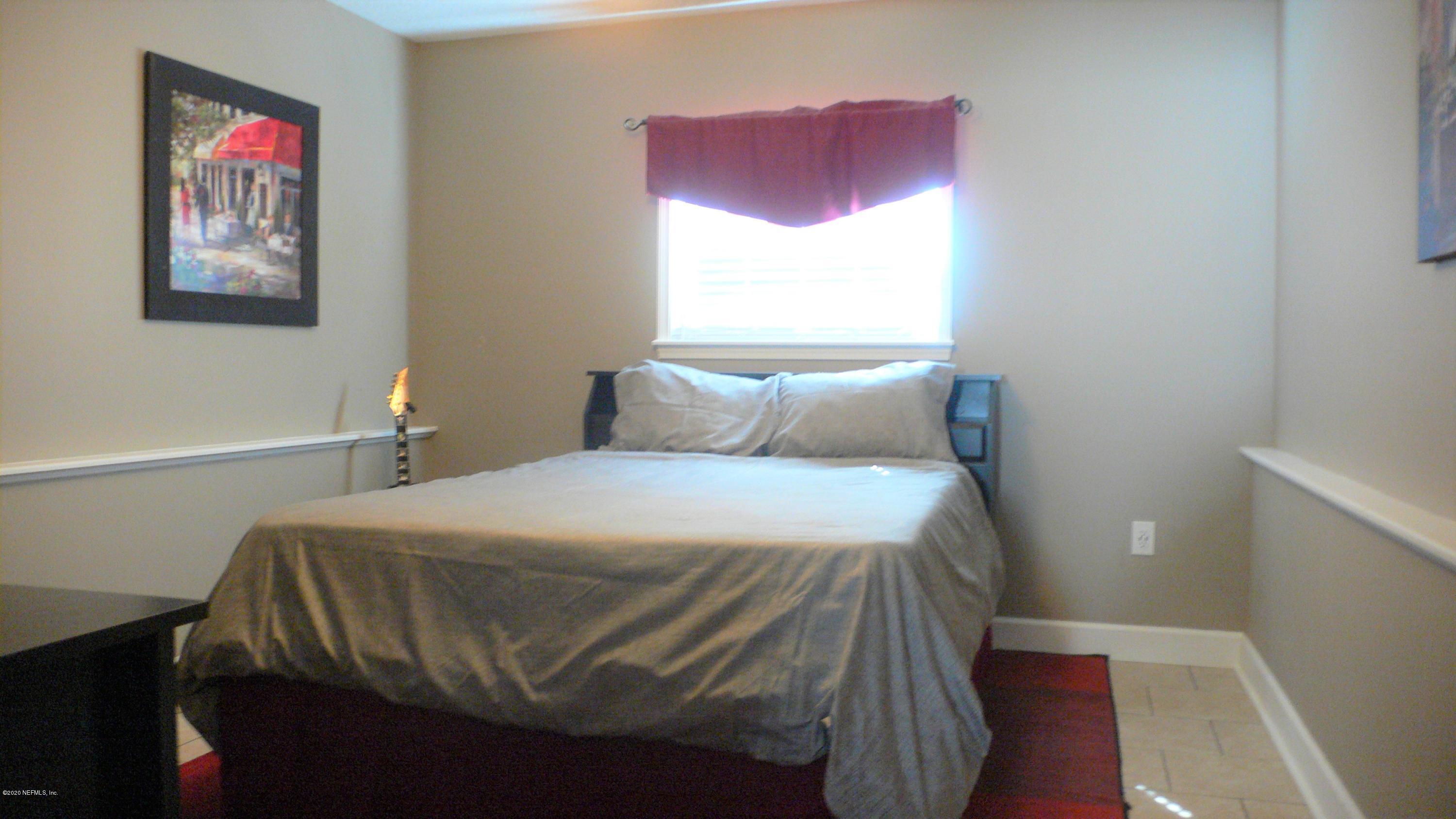 12779 Attrill Road Jacksonville, FL 32258 - Photo 8 of 11 a bedroom with a bed and a window