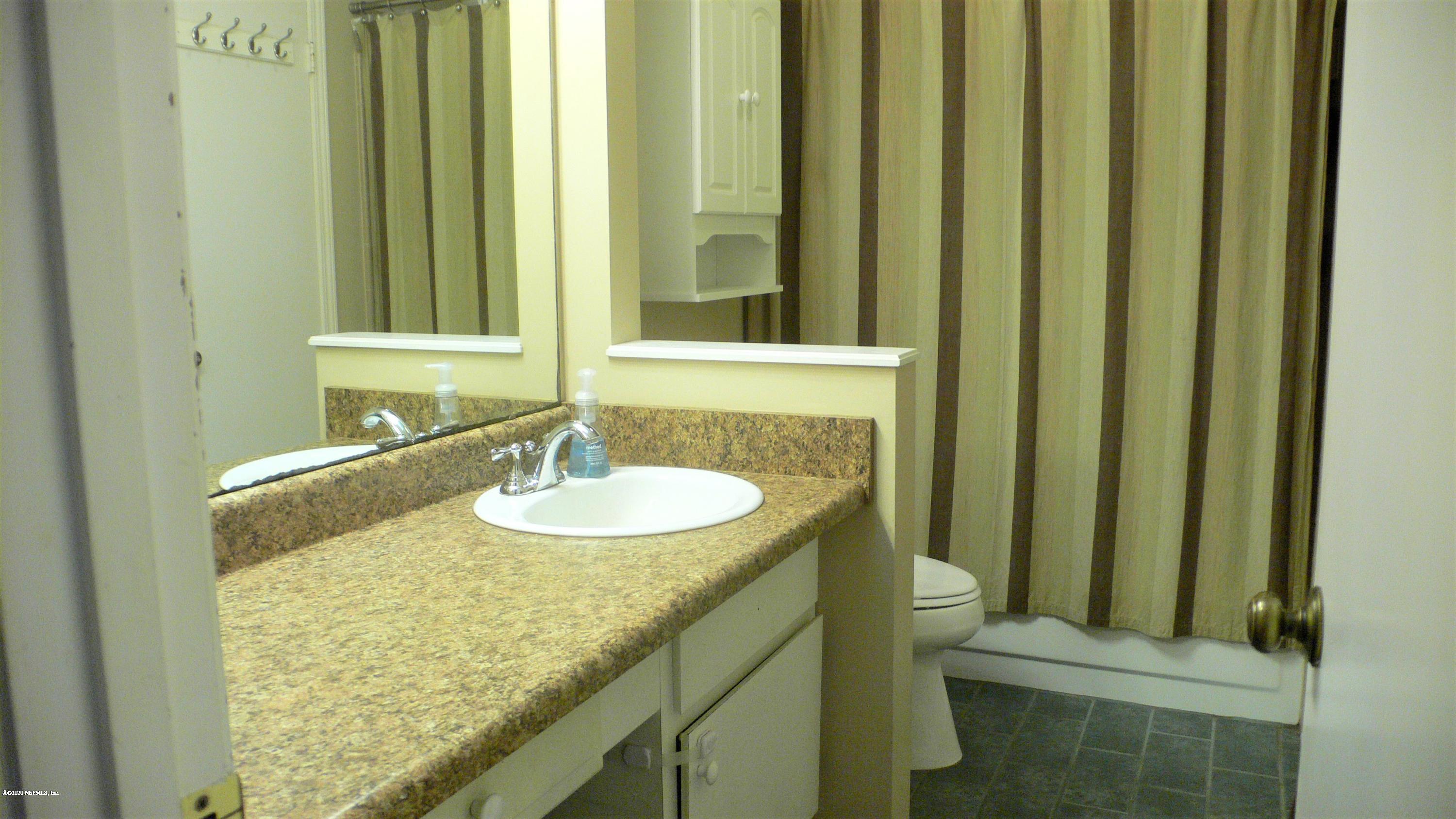 12779 Attrill Road Jacksonville, FL 32258 - Photo 9 of 11 a bathroom with a sink and a mirror