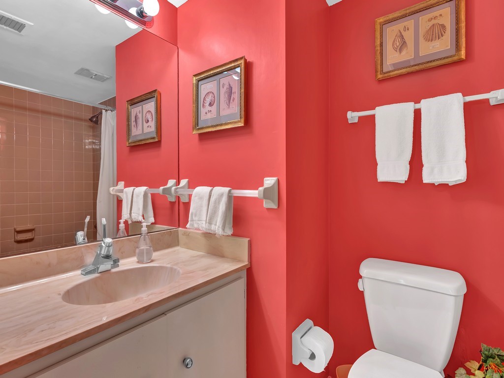 1155 Reef Road, Unit B2 Vero Beach, FL 32963 - Photo 11 of 32 a bathroom with a toilet sink and mirror