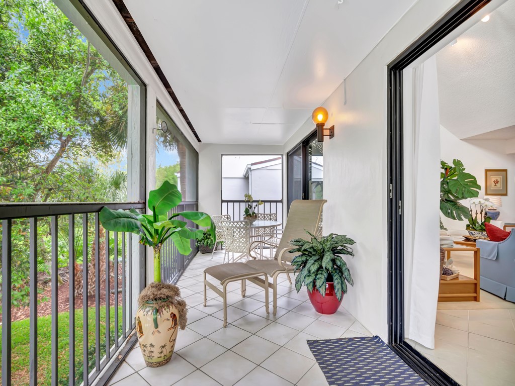 1155 Reef Road, Unit B2 Vero Beach, FL 32963 - Photo 13 of 32 a balcony with potted plants and wooden floor