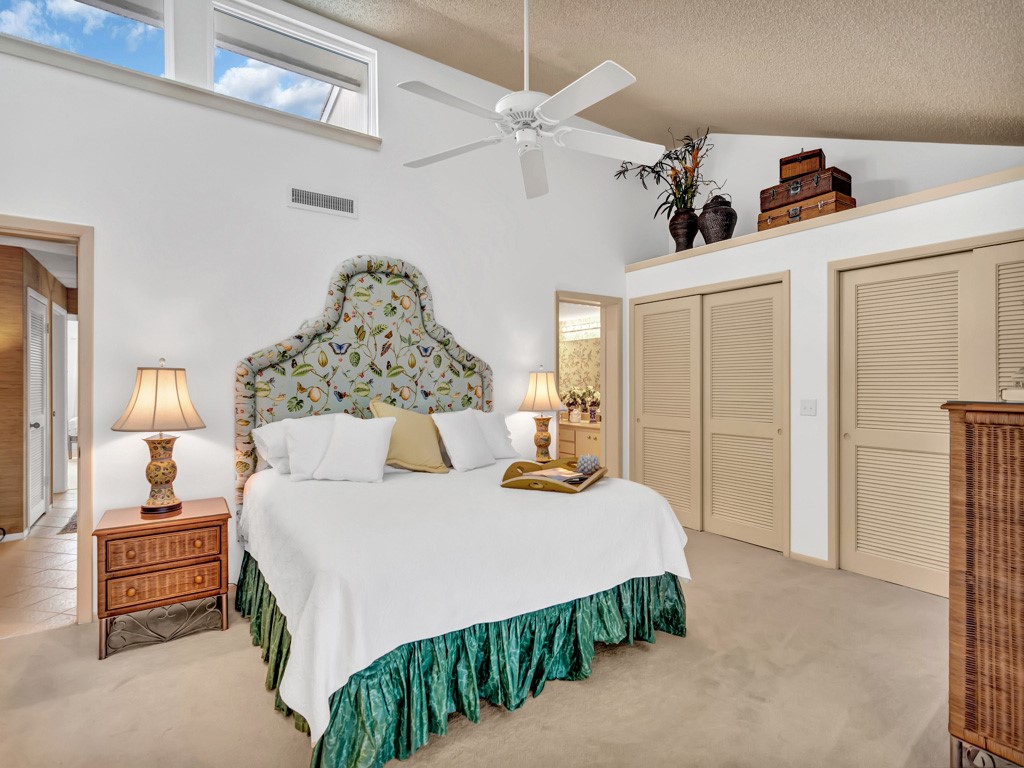 1155 Reef Road, Unit B2 Vero Beach, FL 32963 - Photo 15 of 32 a bedroom with a bed and a walk in closet