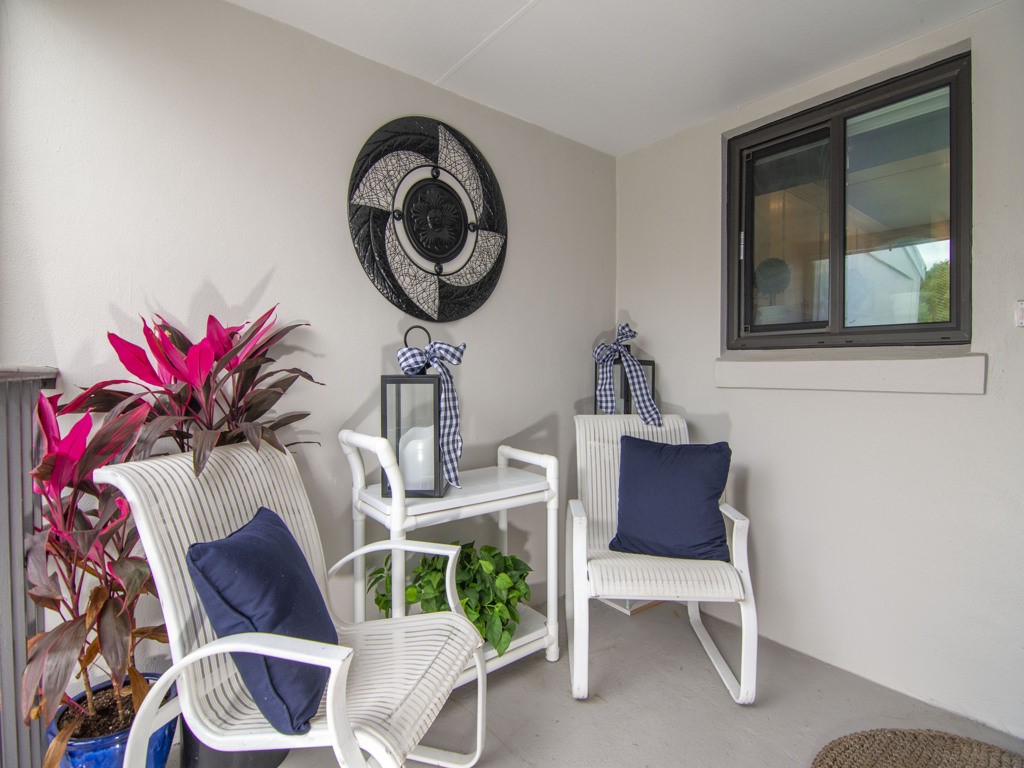 1155 Reef Road, Unit B2 Vero Beach, FL 32963 - Photo 21 of 32 a living room with furniture and a mirror