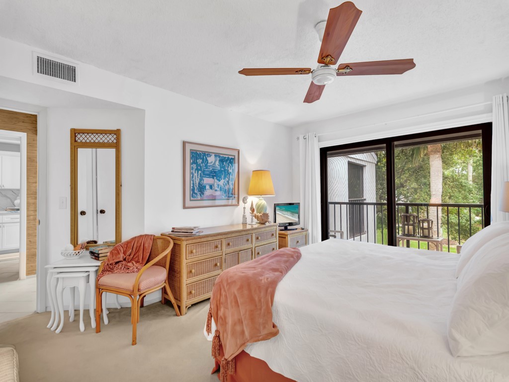 1155 Reef Road, Unit B2 Vero Beach, FL 32963 - Photo 10 of 32 a bedroom with a bed and a large window