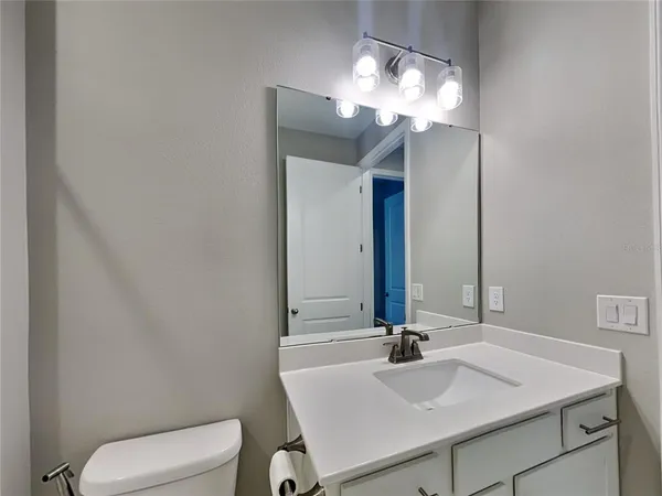 a bathroom with a sink vanity and a mirror