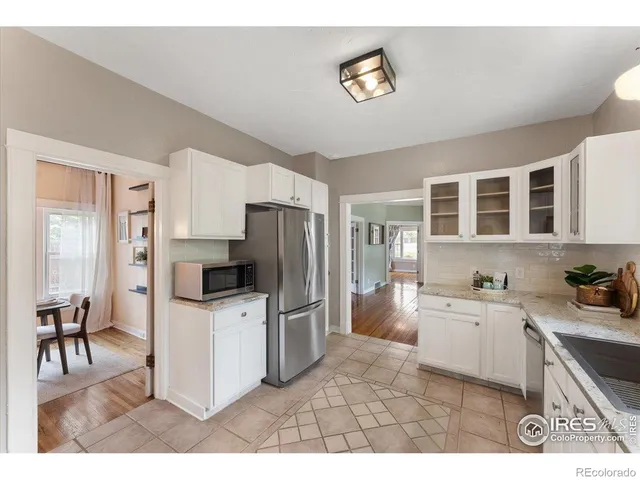 a kitchen with stainless steel appliances a stove a refrigerator and a sink