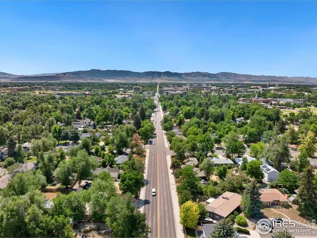 a view of a city with lush green forest