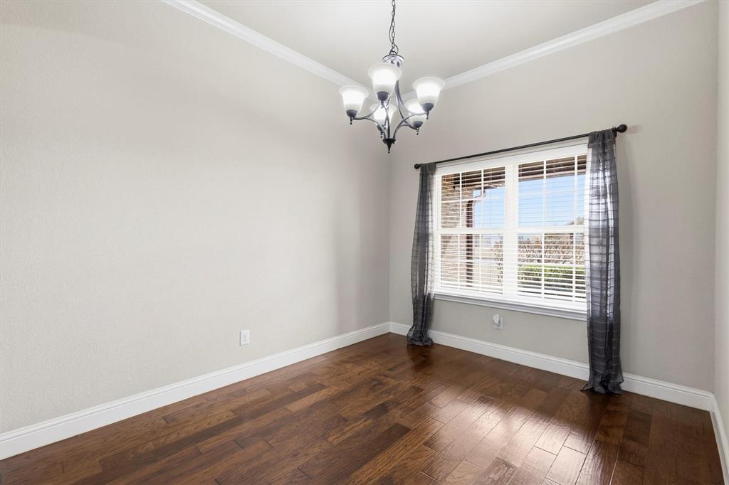 505 Water Fall Lane Nevada, TX 75173 - Photo 11 of 36 a view of an empty room with wooden floor and a window
