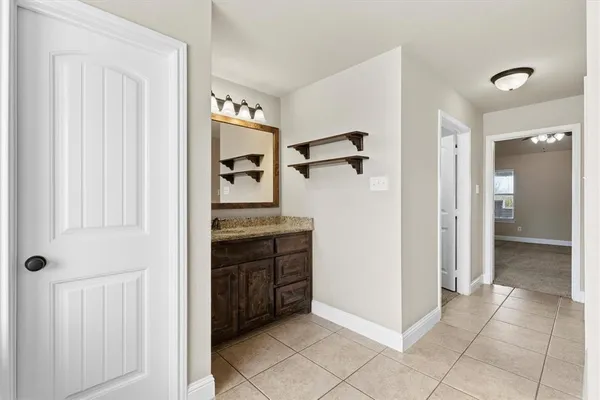 an empty room with closet and a hallway