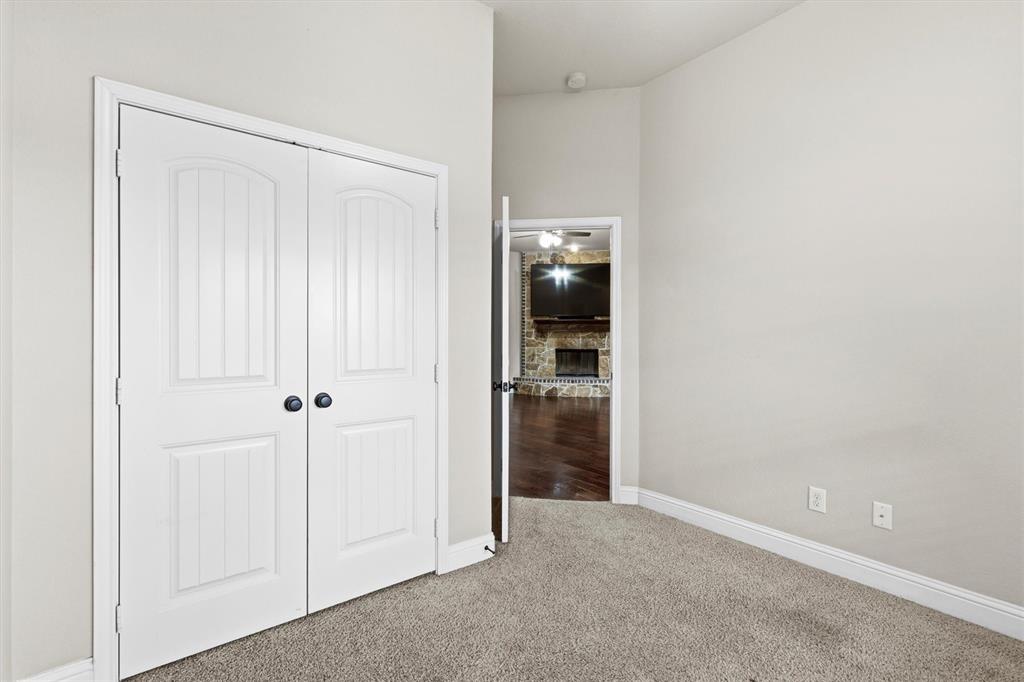 505 Water Fall Lane Nevada, TX 75173 - Photo 18 of 36 an empty room with closet and a hallway