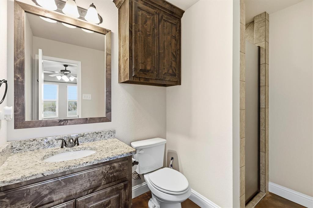 505 Water Fall Lane Nevada, TX 75173 - Photo 20 of 36 a bathroom with a granite countertop sink toilet and mirror