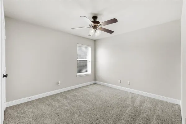 a bathroom with a granite countertop sink a toilet a mirror and shower