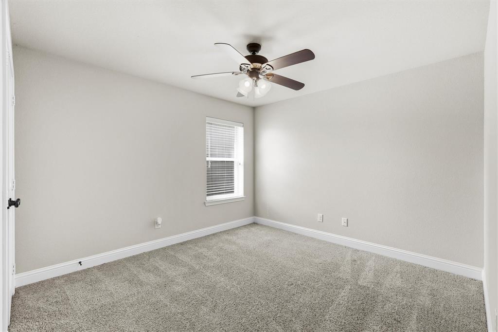 505 Water Fall Lane Nevada, TX 75173 - Photo 23 of 36 an empty room with a window and a fan