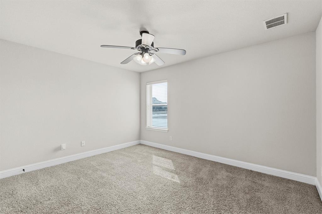 505 Water Fall Lane Nevada, TX 75173 - Photo 26 of 36 an empty room with a window and a fan