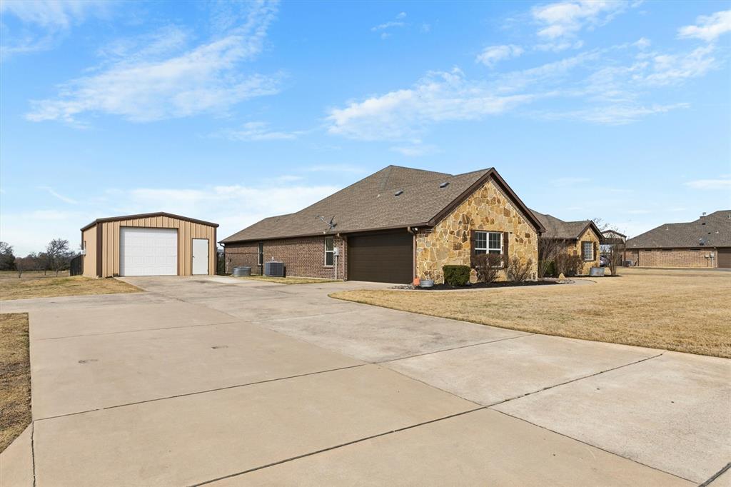 505 Water Fall Lane Nevada, TX 75173 - Photo 31 of 36 a front view of a house with a yard and garage