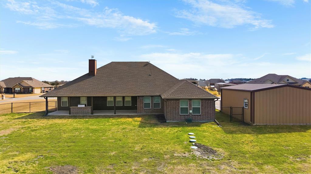 505 Water Fall Lane Nevada, TX 75173 - Photo 32 of 36 a front view of a house with a yard table and chairs