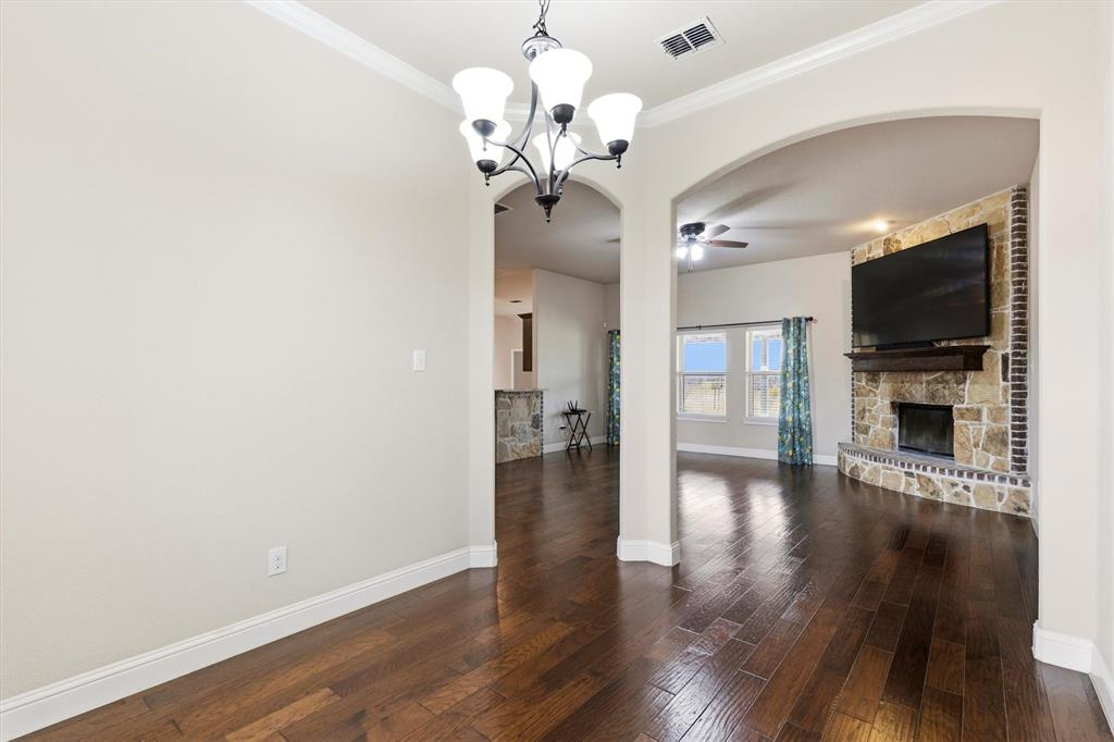 505 Water Fall Lane Nevada, TX 75173 - Photo 6 of 36 a view of a livingroom with wooden floor and a chandelier