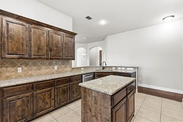 a kitchen with a sink a stove and cabinets