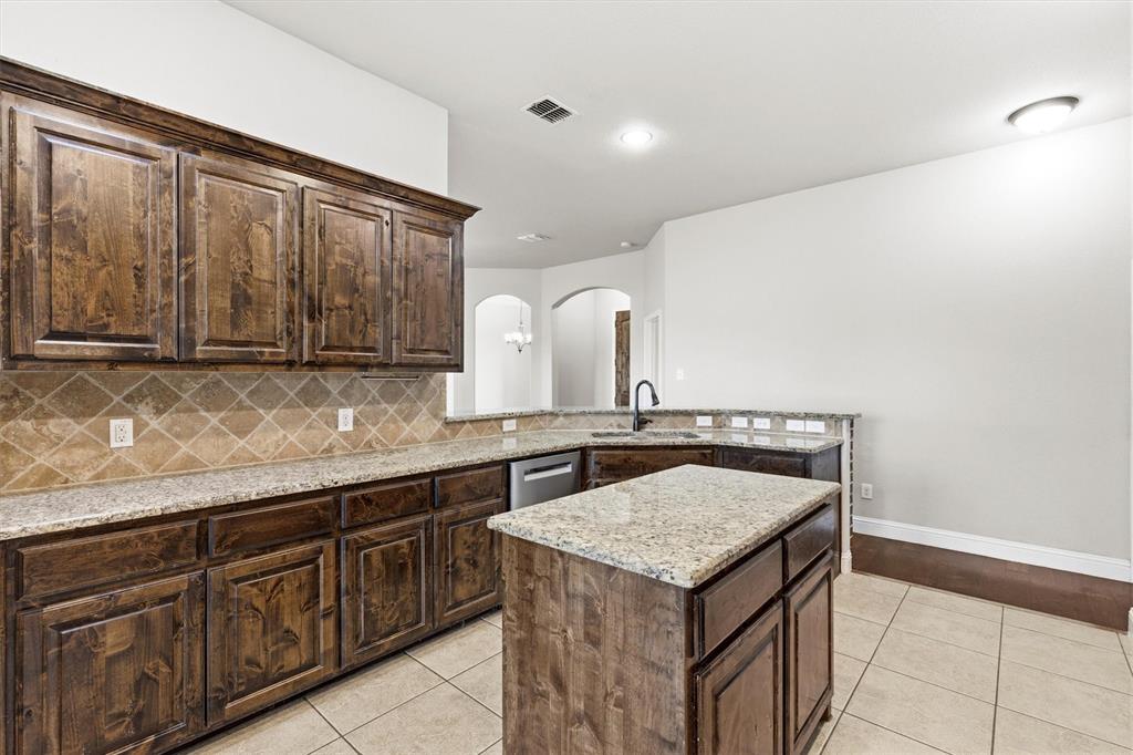505 Water Fall Lane Nevada, TX 75173 - Photo 8 of 36 a kitchen with a sink a stove and cabinets