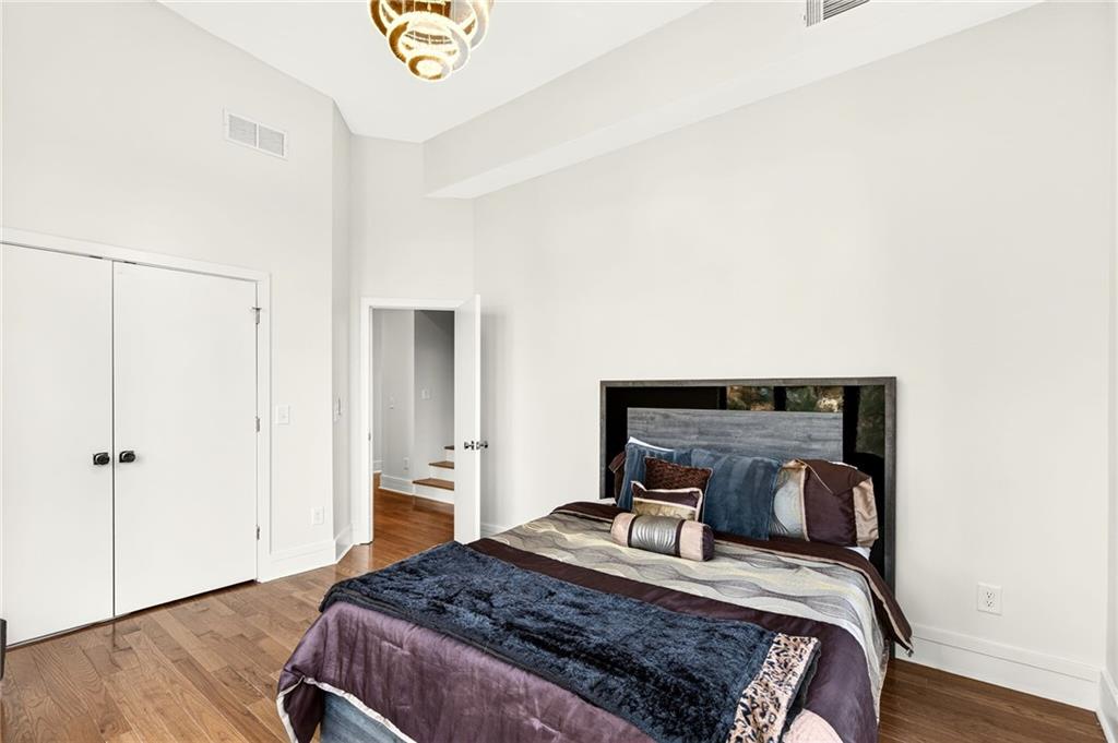345 Pinecrest Road Northeast Atlanta, GA 30342 - Photo 42 of 70 a bedroom with a bed and wooden floor