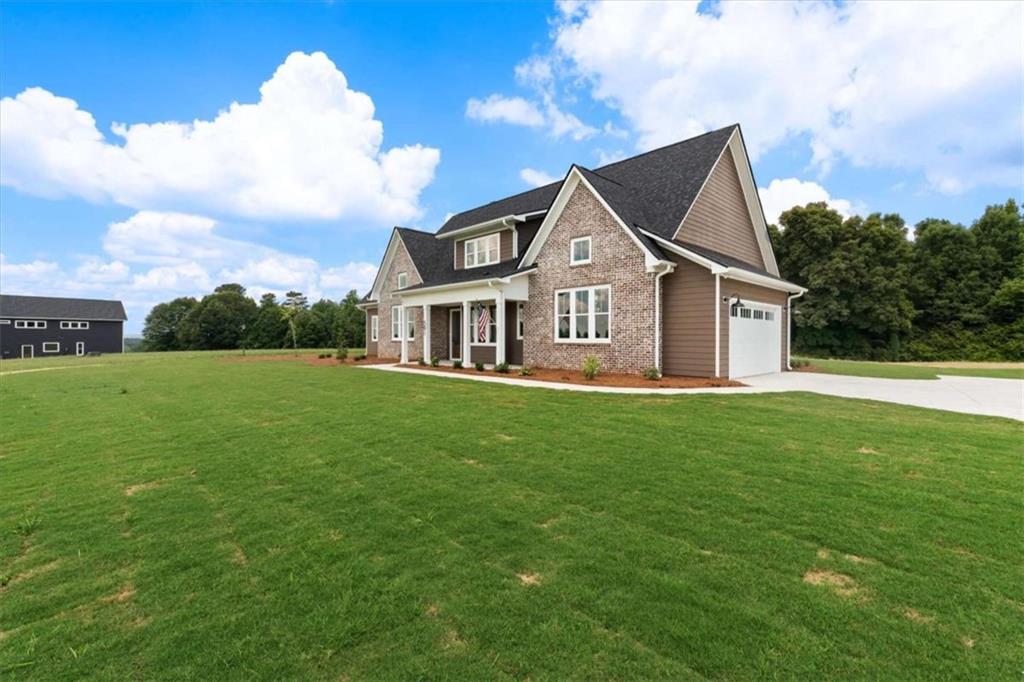 591 Welcome Road Roopville, GA 30170 - Photo 5 of 60 a front view of a house with a garden