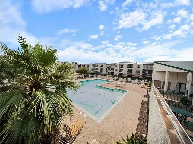 a view of swimming pool with outdoor seating and plants