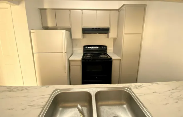 a bedroom with a bed and a stove