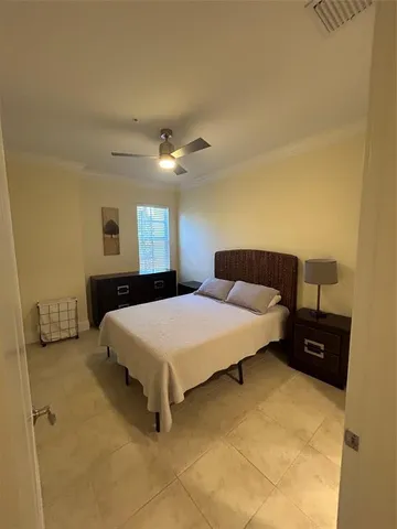 a bedroom with a bed and a large mirror